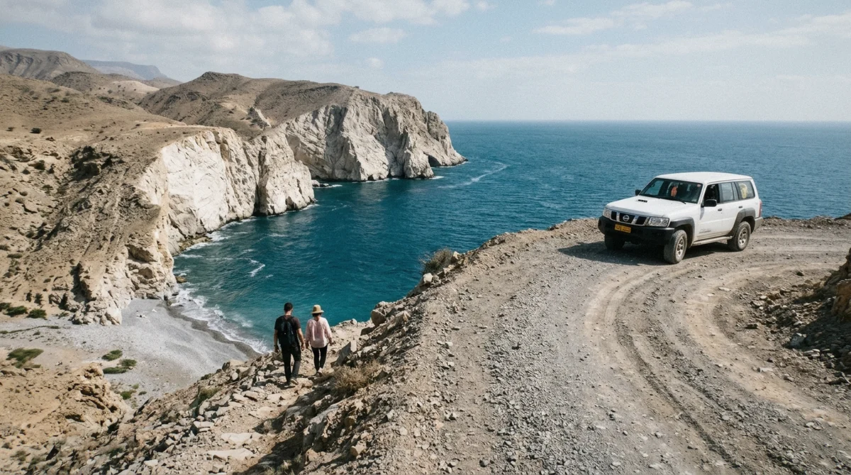 A 4x4 parked on the gravel track above the white rocks and blue water at Fins Beach