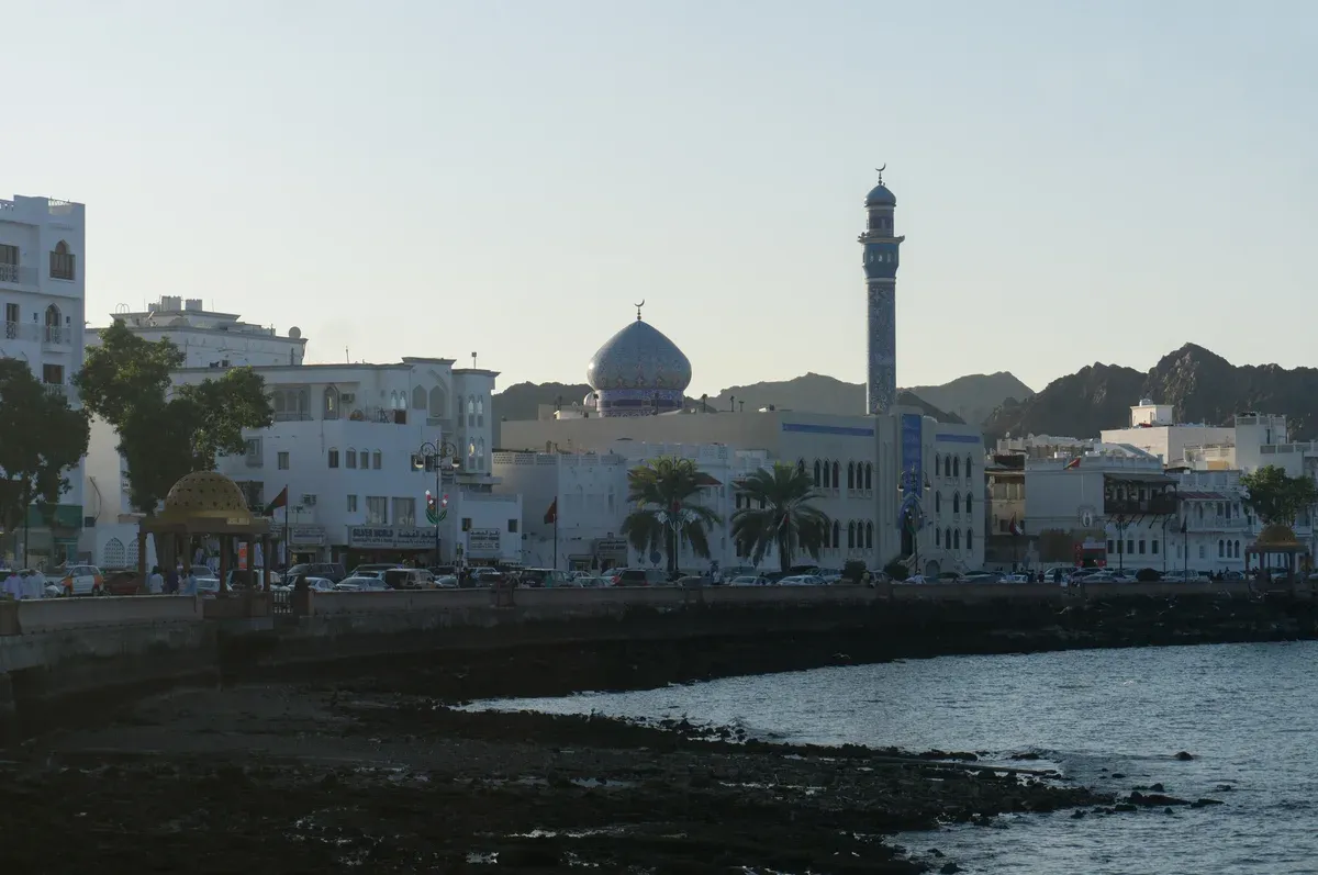 Muttrah Corniche in Muscat with its blue-domed mosque, the city base for Wadi Shab tours with pickup